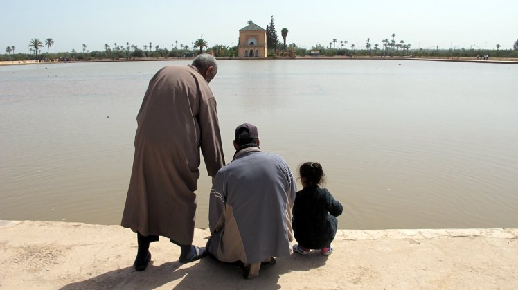 Three generations feeding the fish in Menara Park
